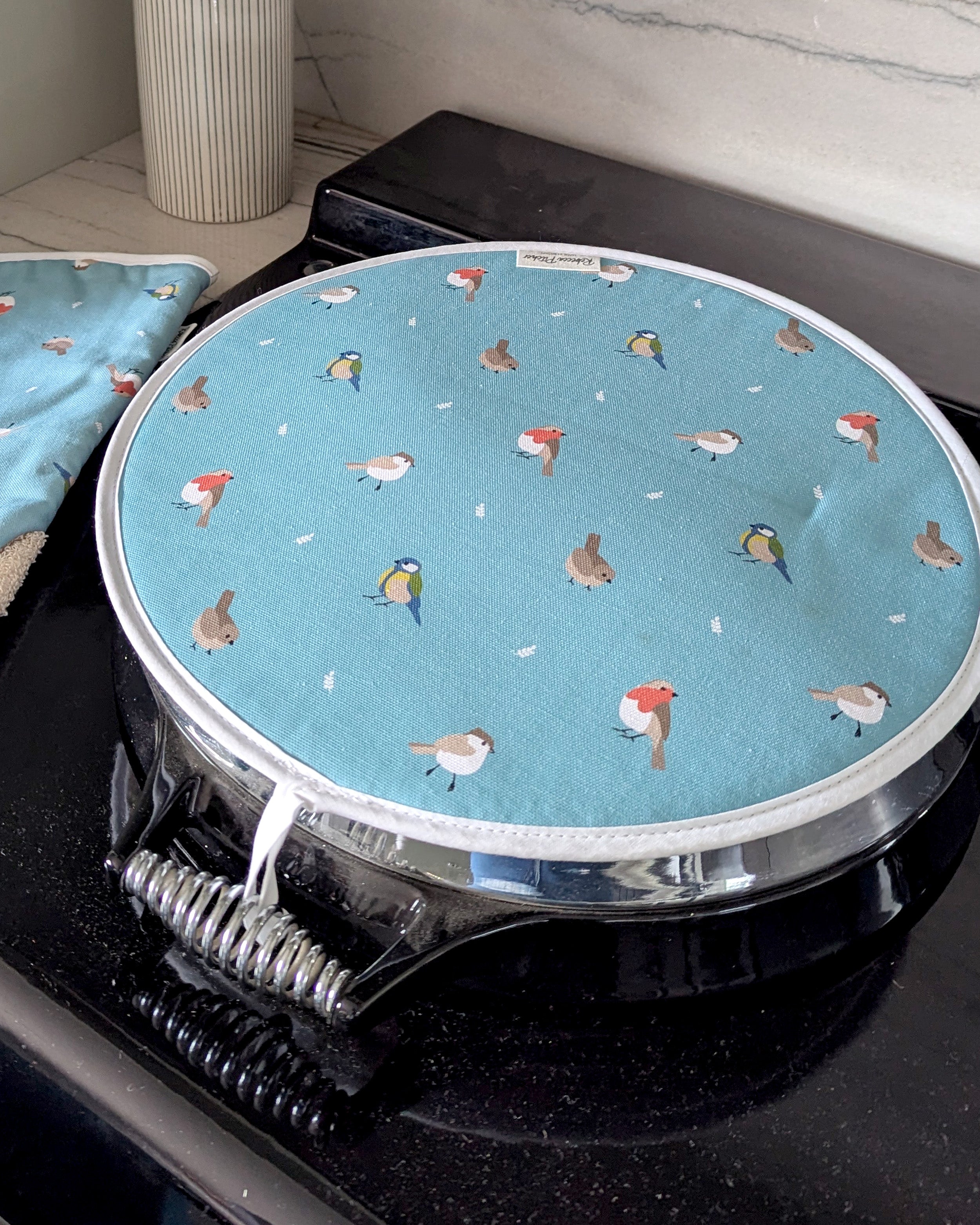 Ocean Blue Bird design hob cover on a stove top