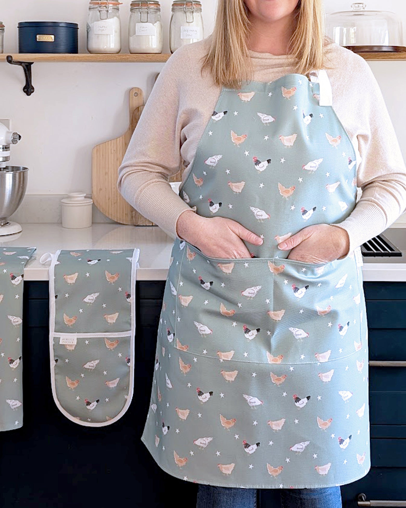 Rebecca Pitcher wearing a green chicken patterned apron in a kitchen setting