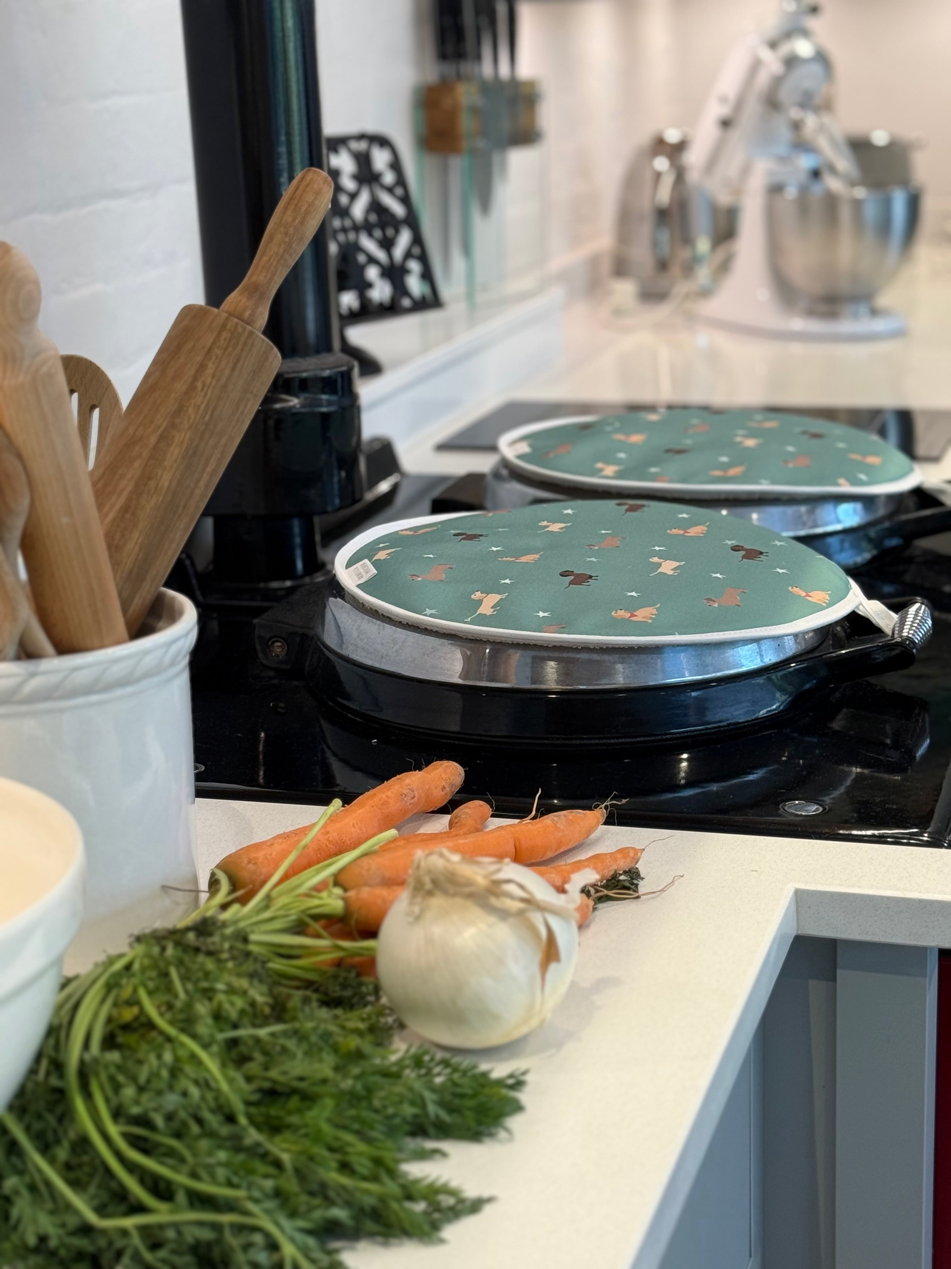 Green dachshund design hob covers in a kitchen setting