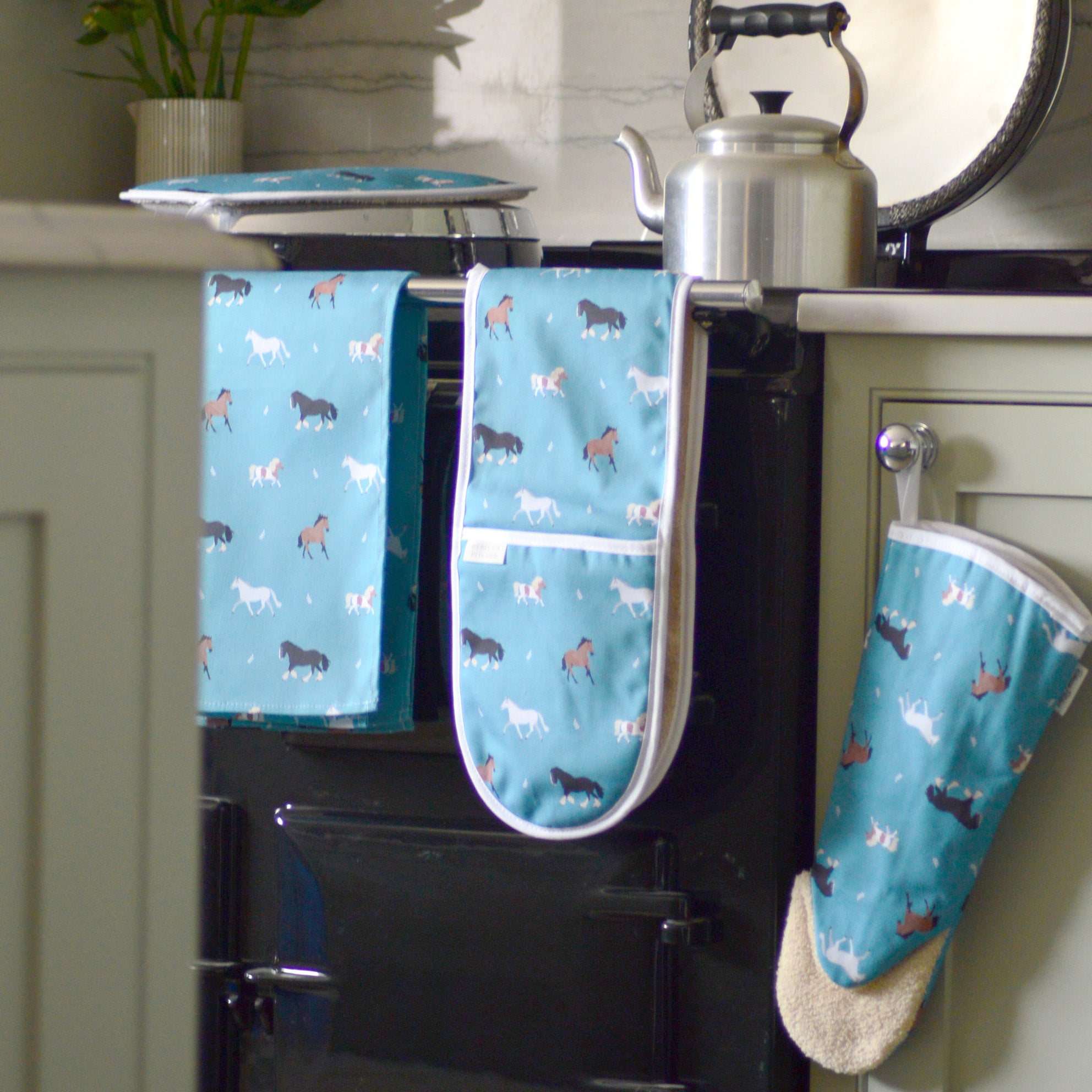 Teal Blue Horse kitchen linens on a range cooker