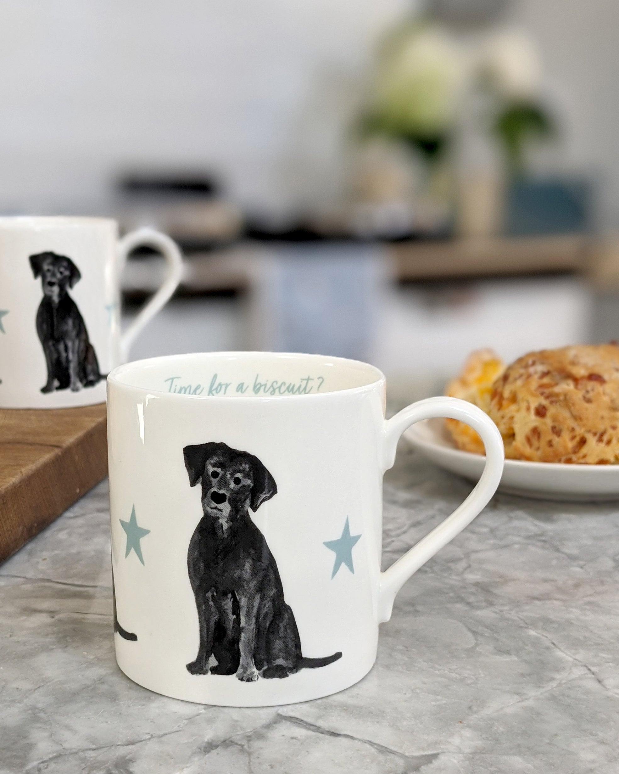 Mug with a black labrador dog illustration on a kitchen counter 