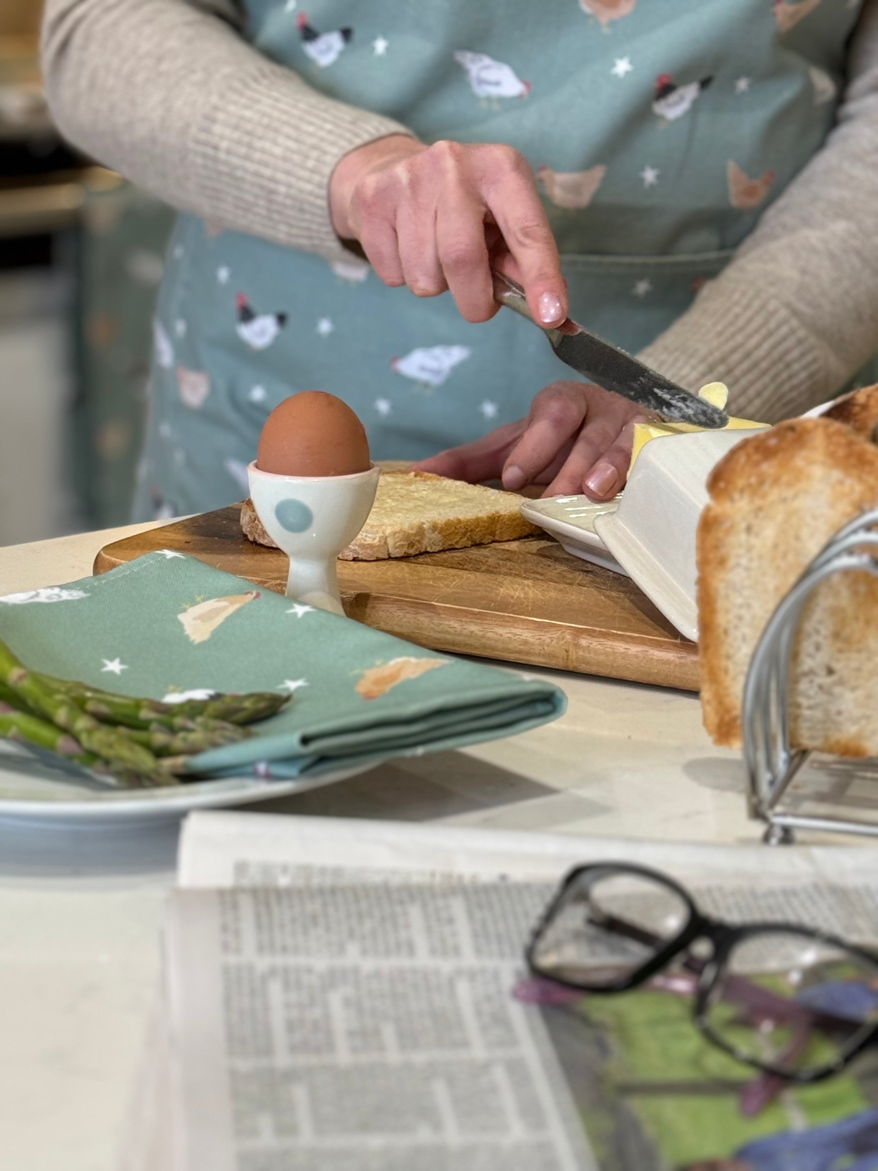 Chicken pattern kitchen textiles in a breakfast kitchen setting