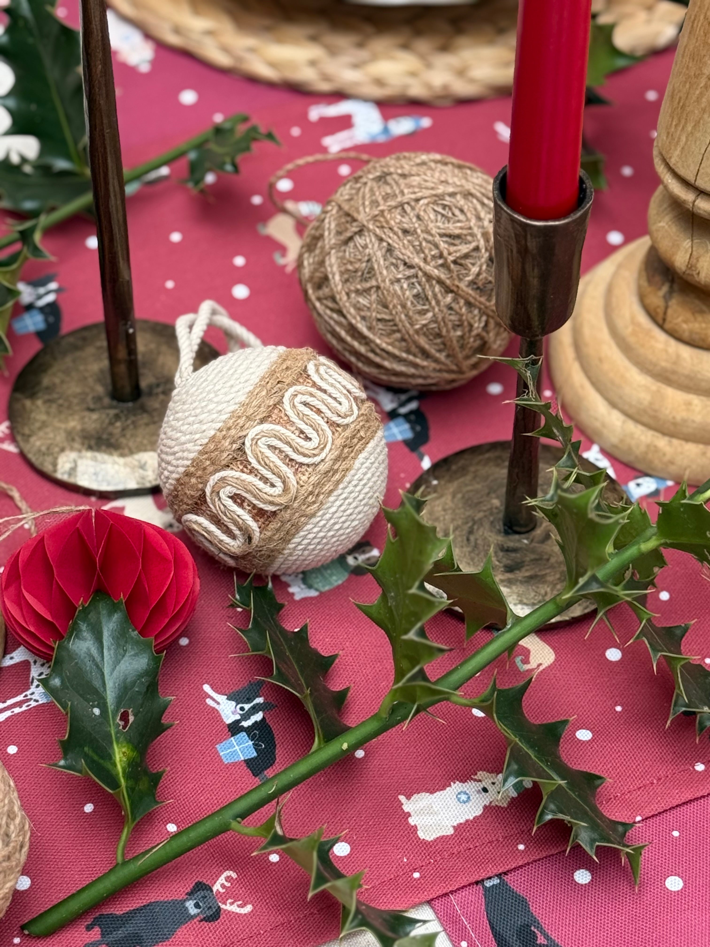 Decorative Christmas scene with baubles, holly, and red Christmas Dogs desgn table runner
