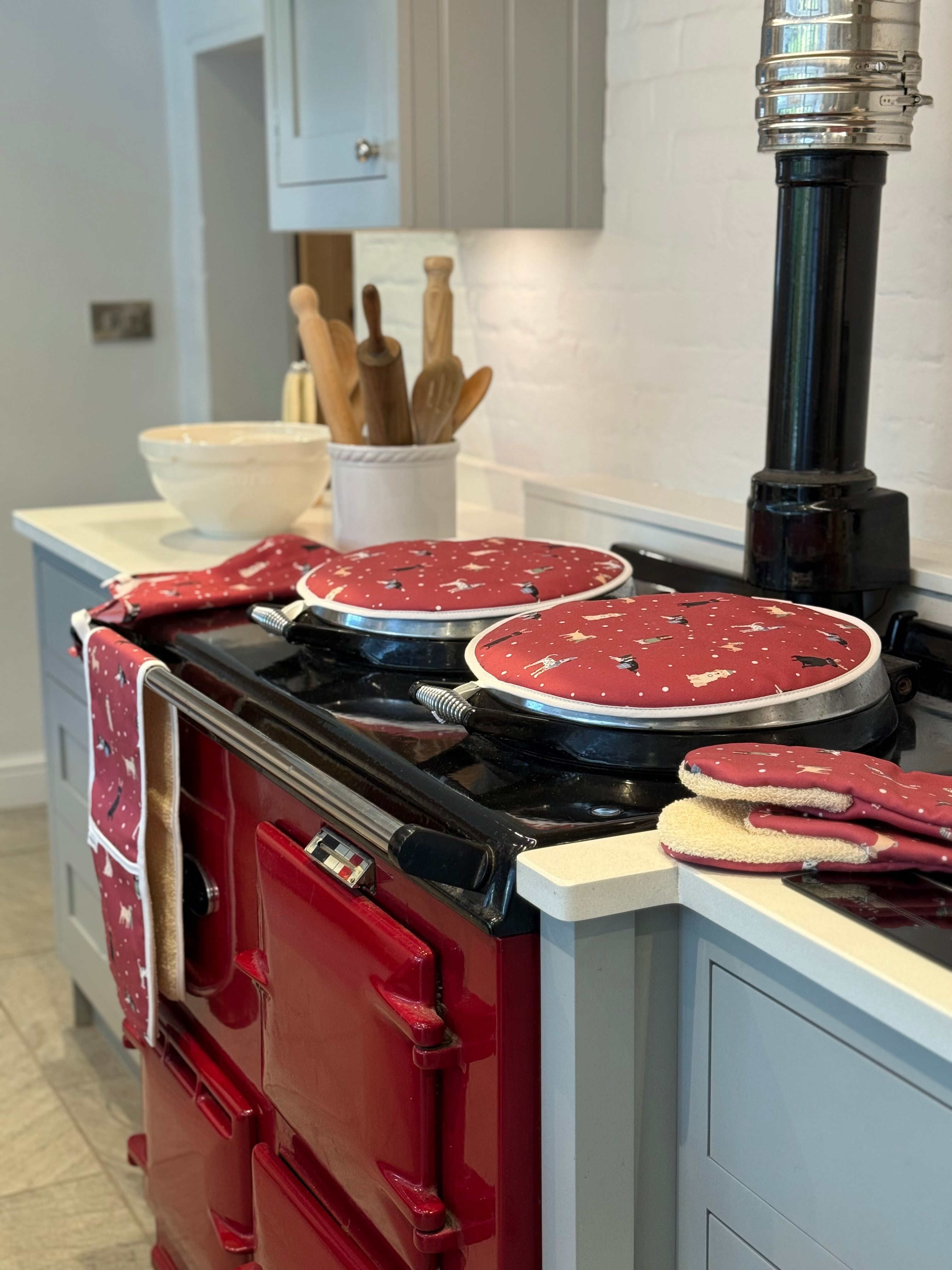 Red Aga range cooker with Christmas Dogs hob covers and kitchen textiles 
