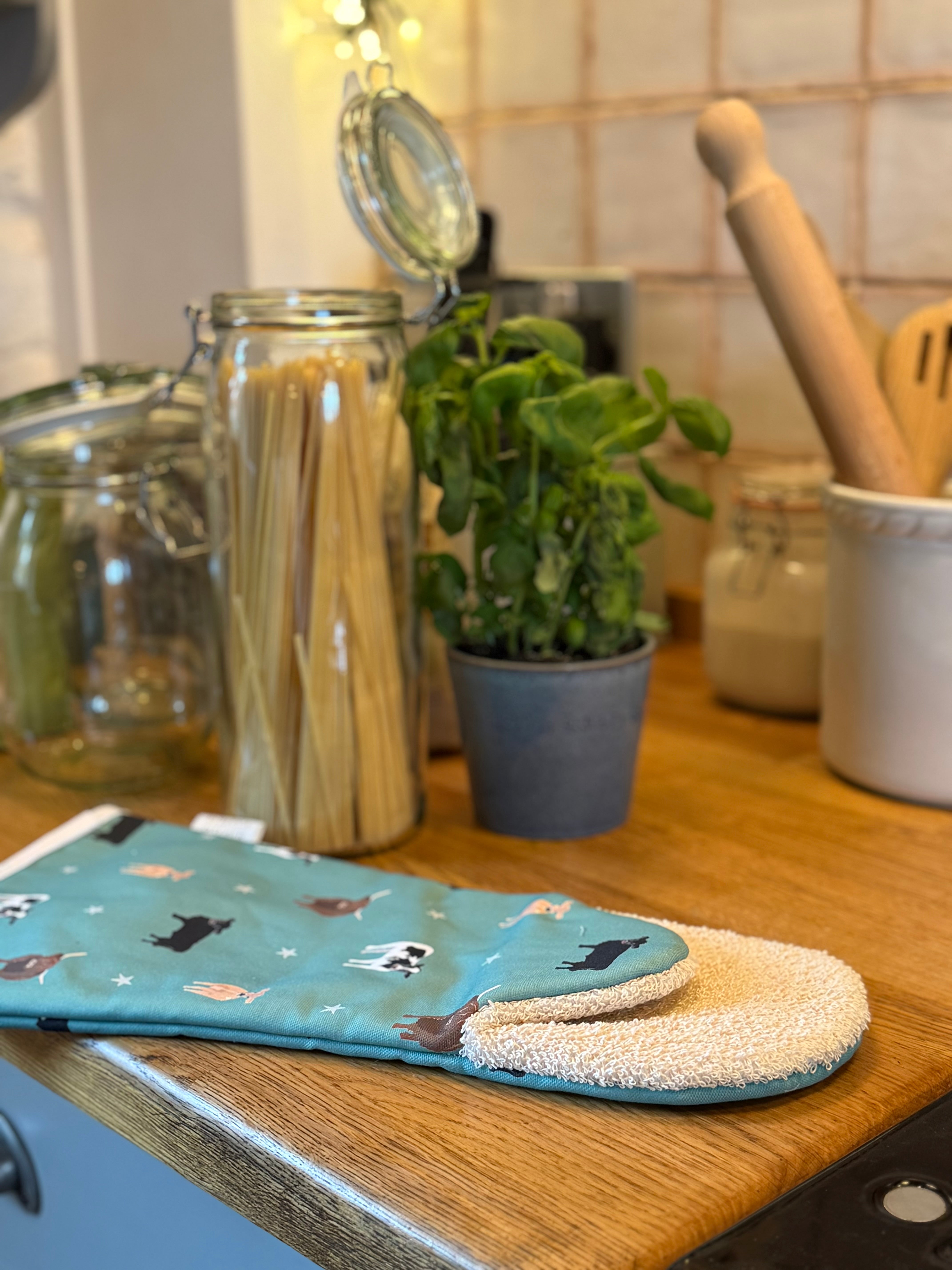 Green cow design oven gauntlet in a country kitchen setting