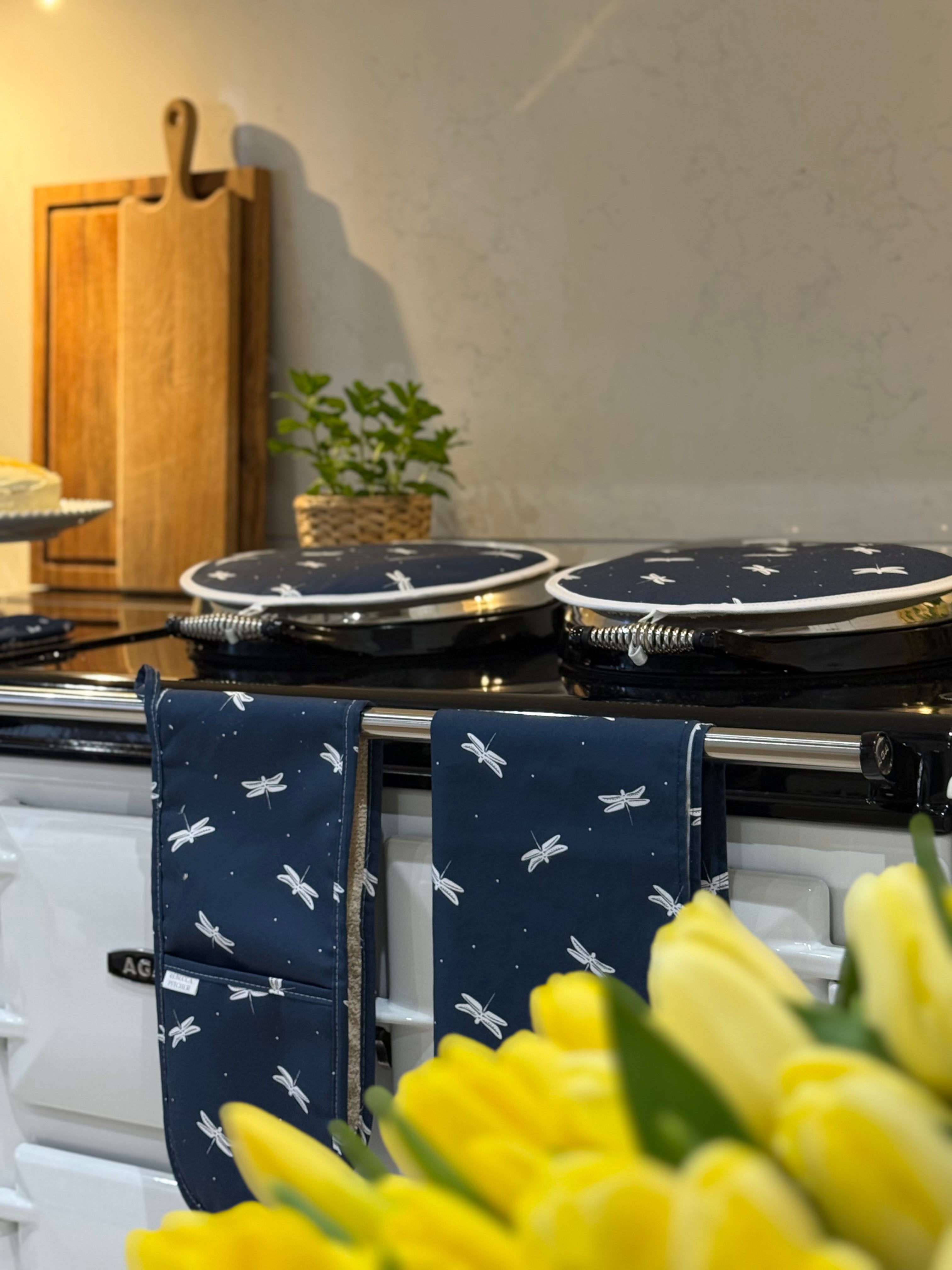 Navy oven gloves, tea towel and hob covers with a dragonfly pattern