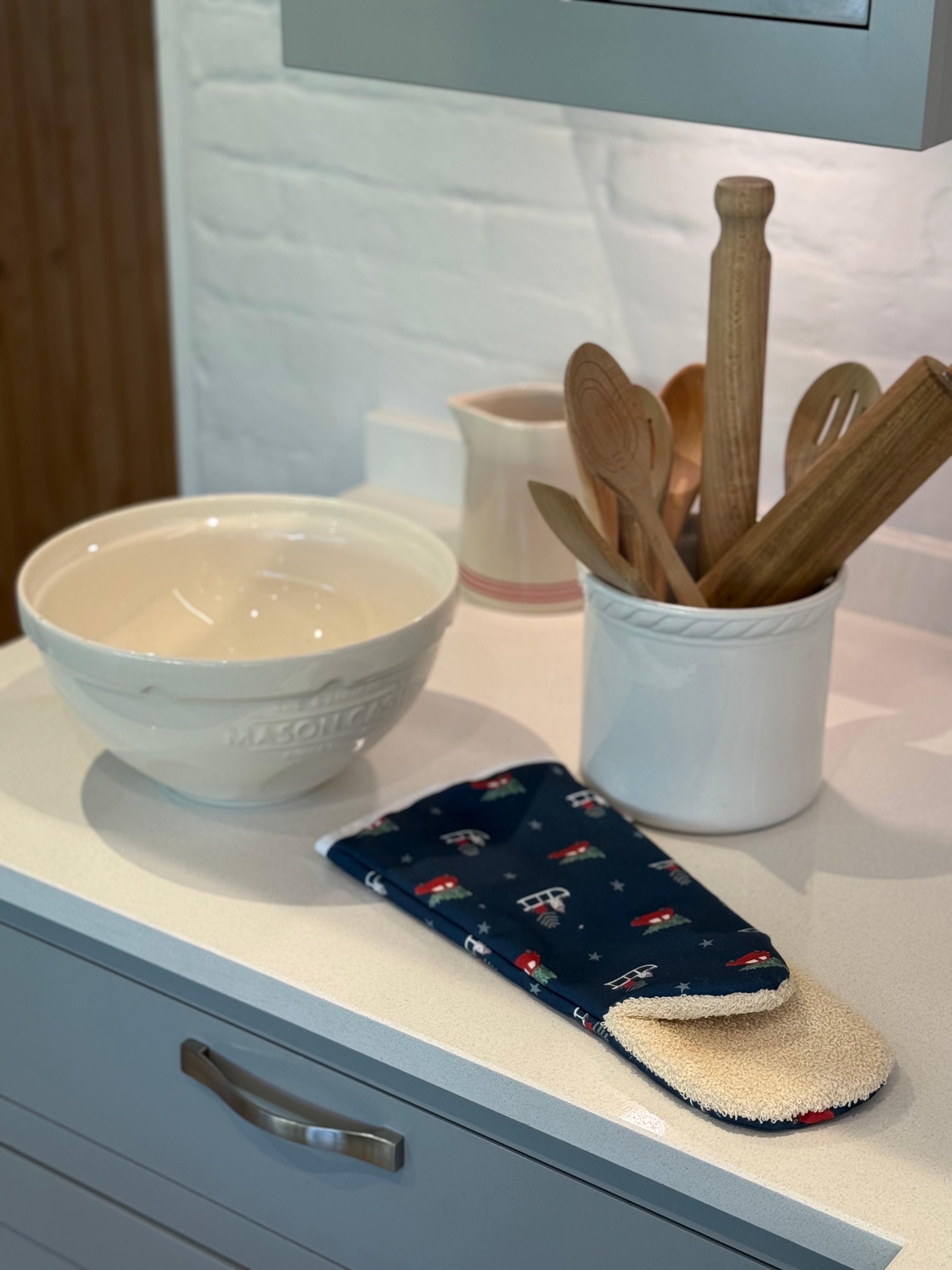 Kitchen counter with a bowl, Christmas oven gauntlet, and utensils
