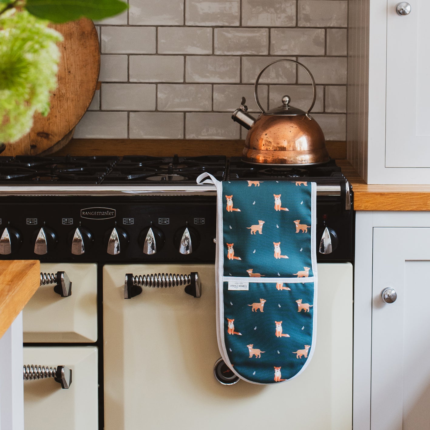 Green fox oven gloves in a country kitchen