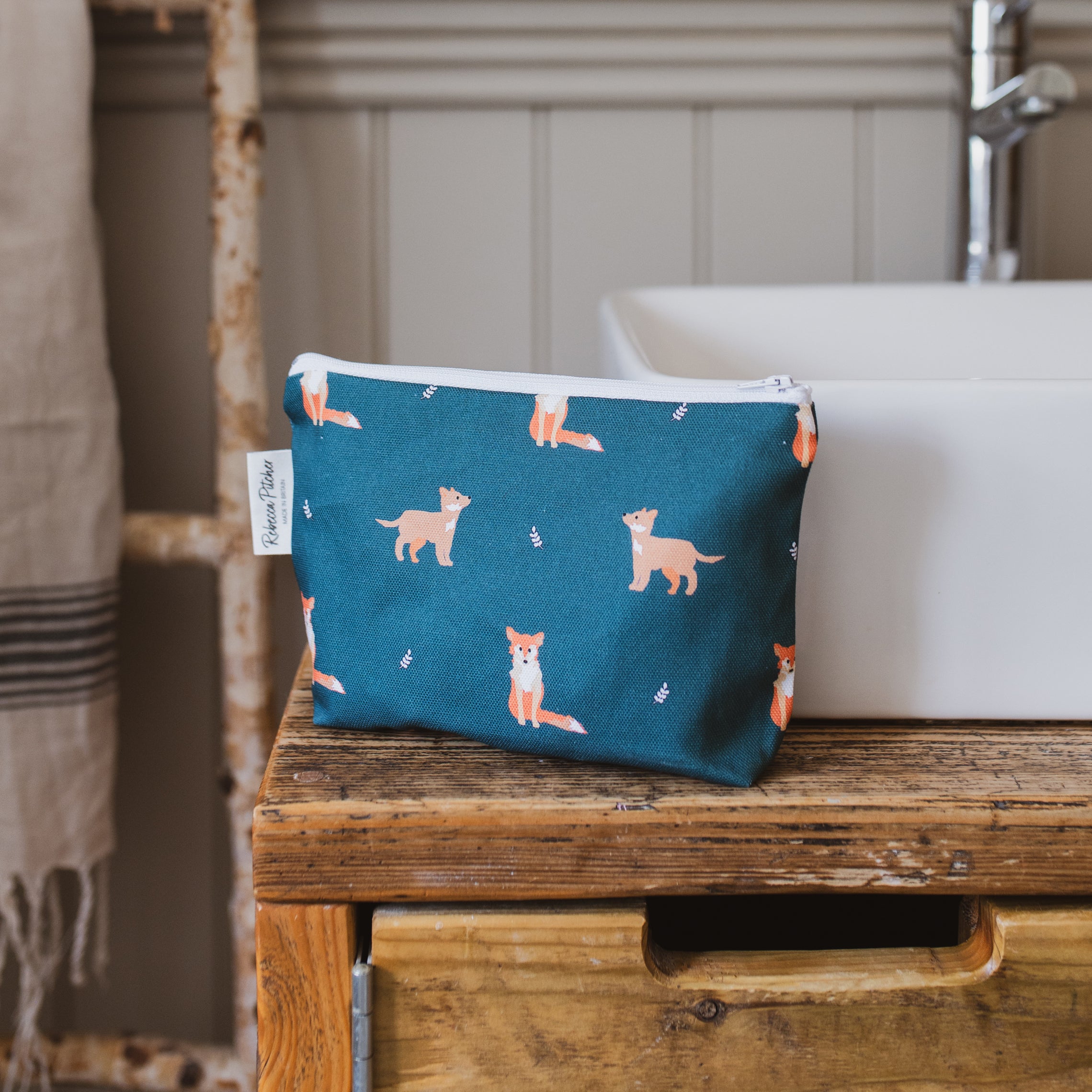 green fox makeup bag by sink