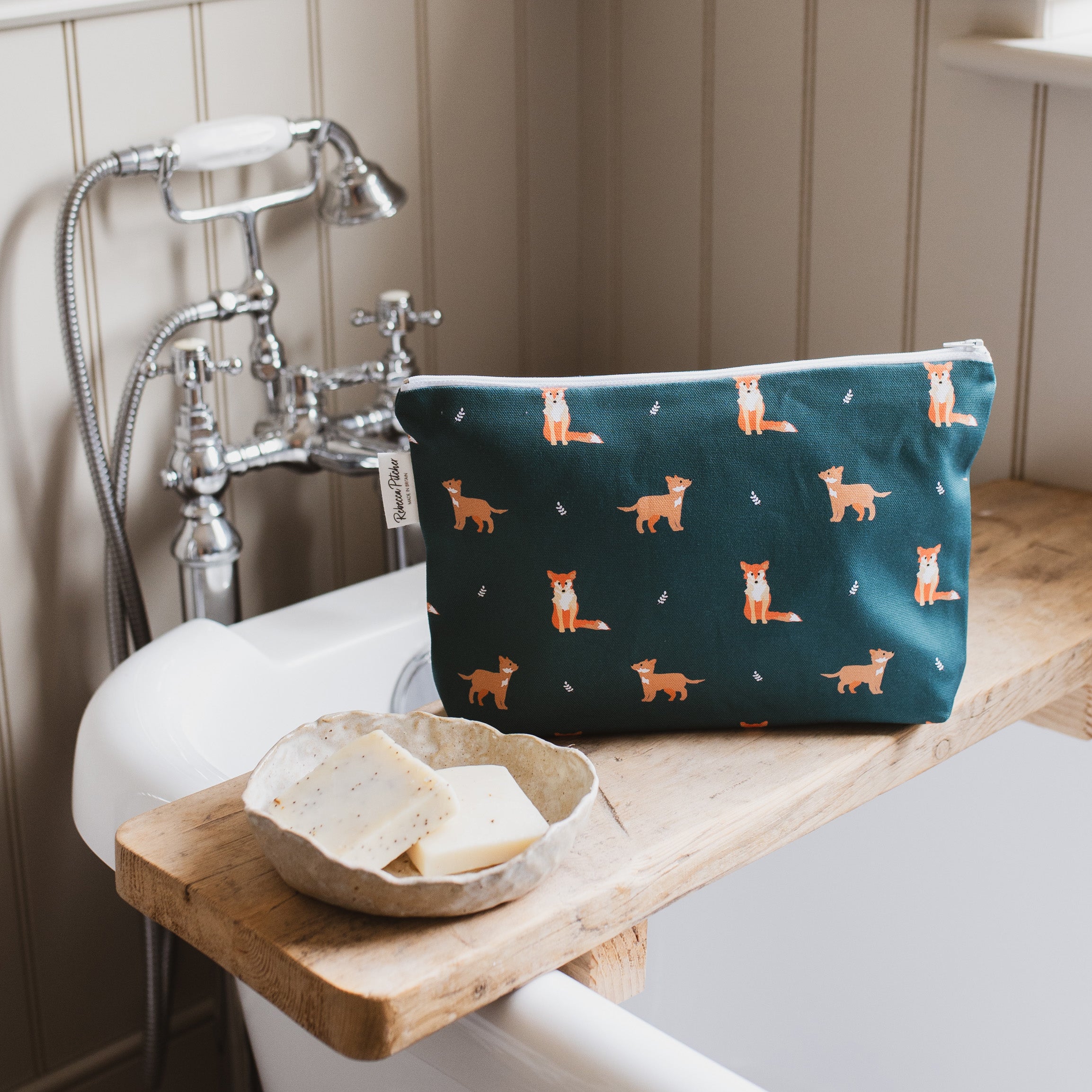 dark green fox washbag in a bathroom