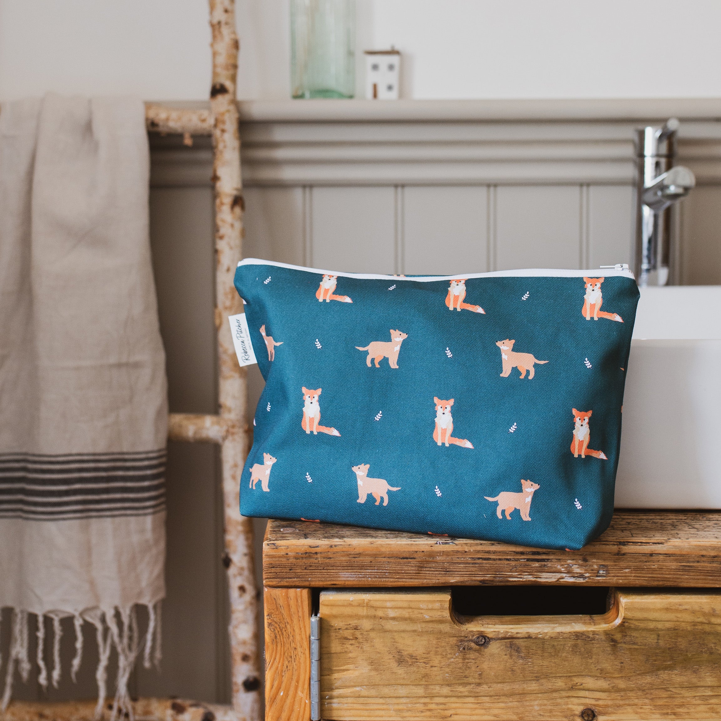 dark green fox washbag in a bathroom