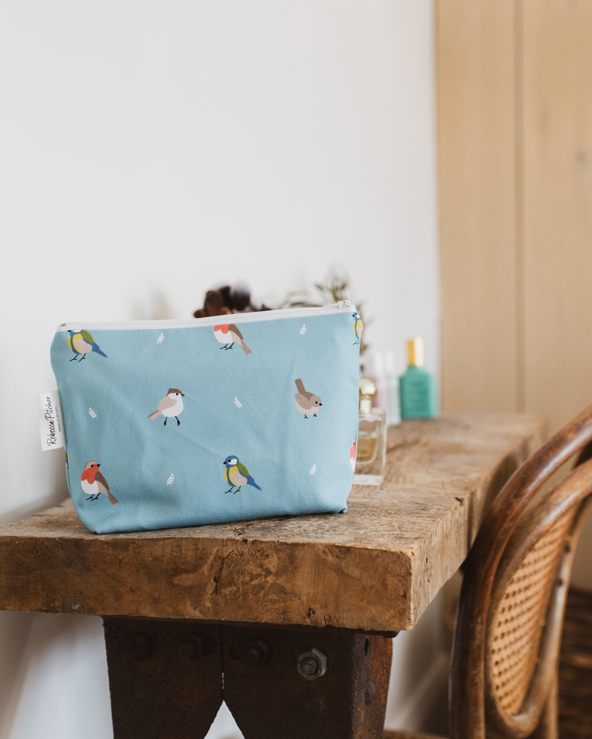 Blue makeup with bird design on a wooden dressing table