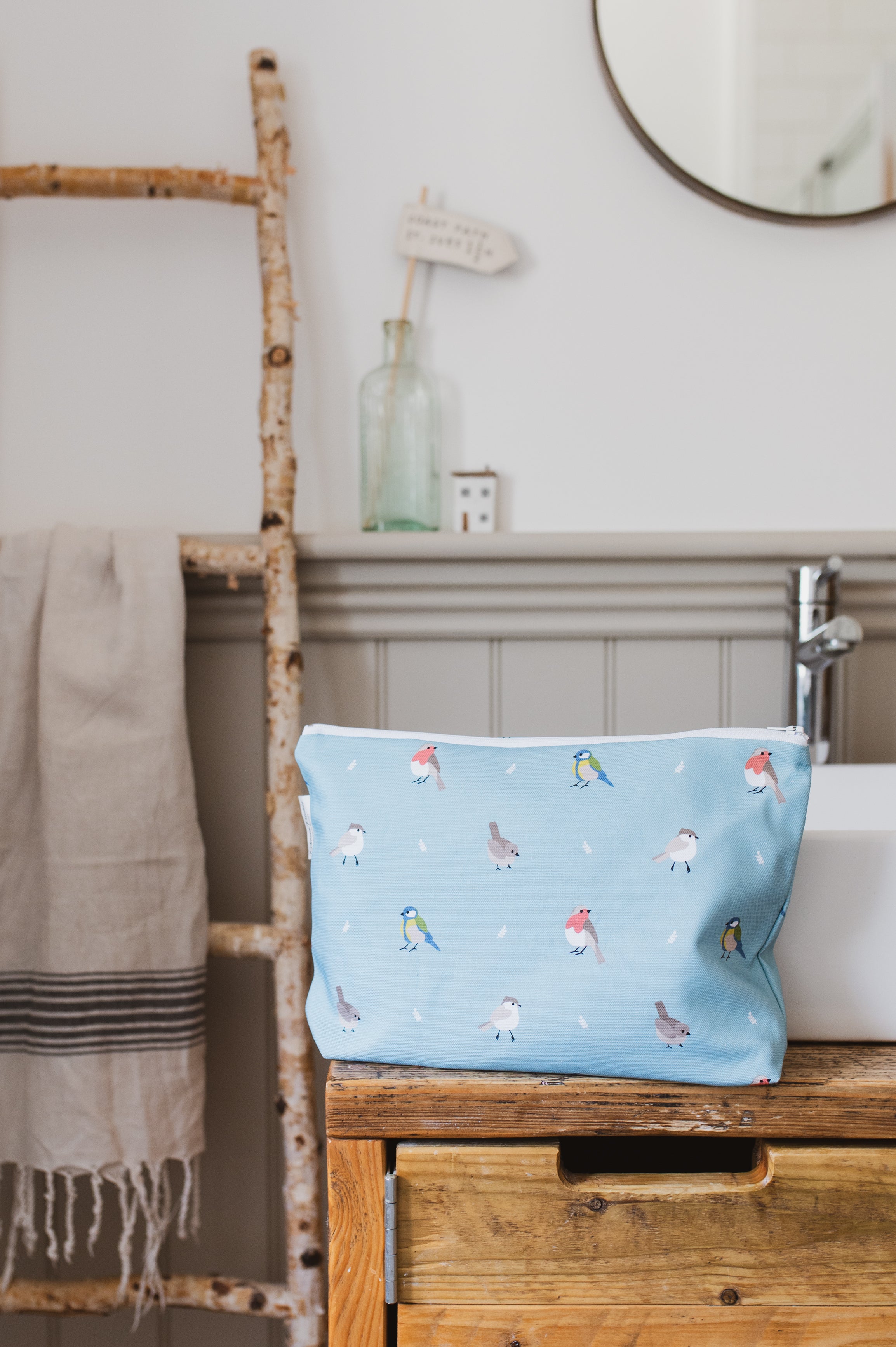 Teal Garden Birds Washbag in a bathroom