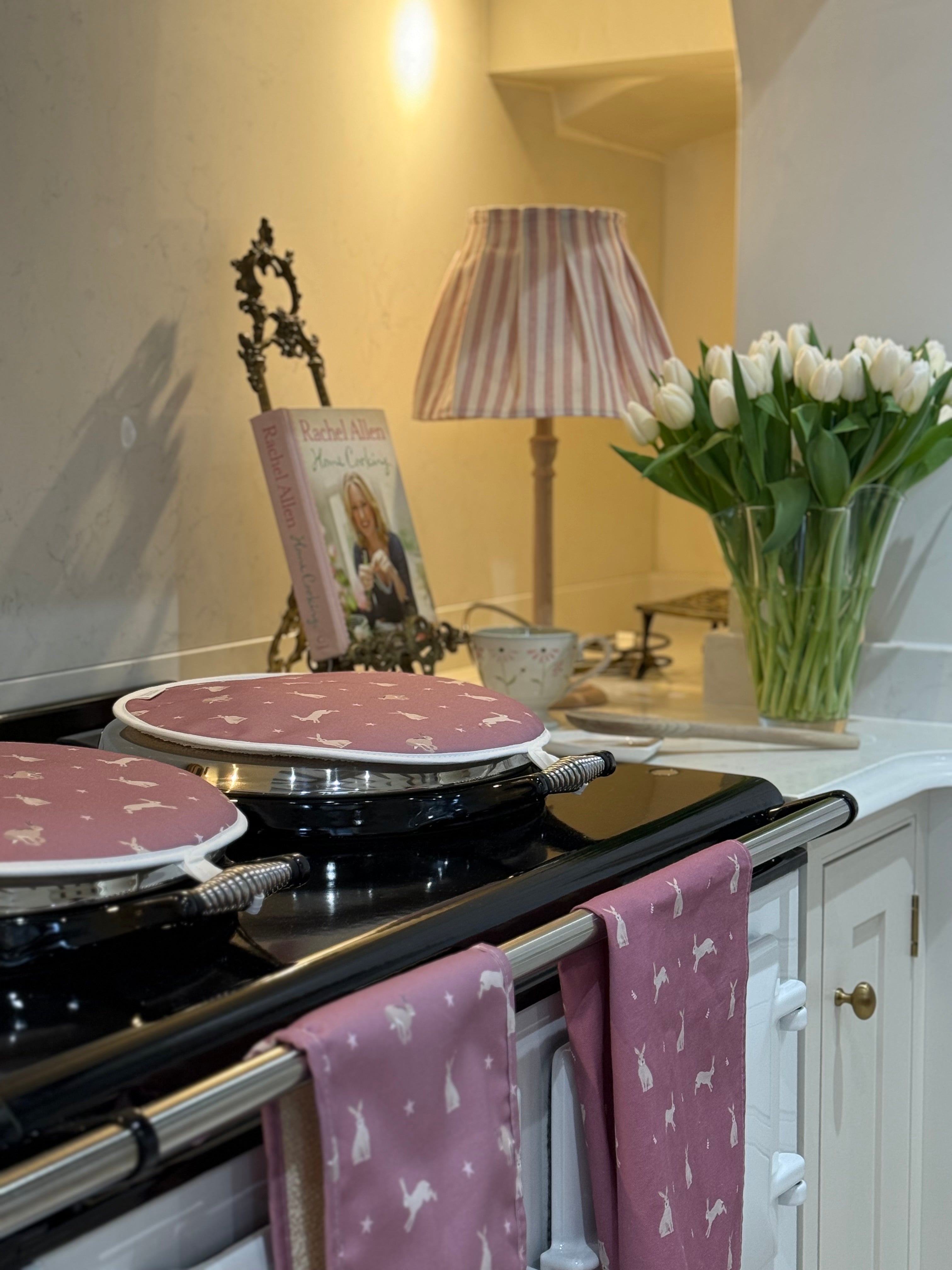 Pink Hare pattern hob covers, oven gloves and tea towel in a country kitchen