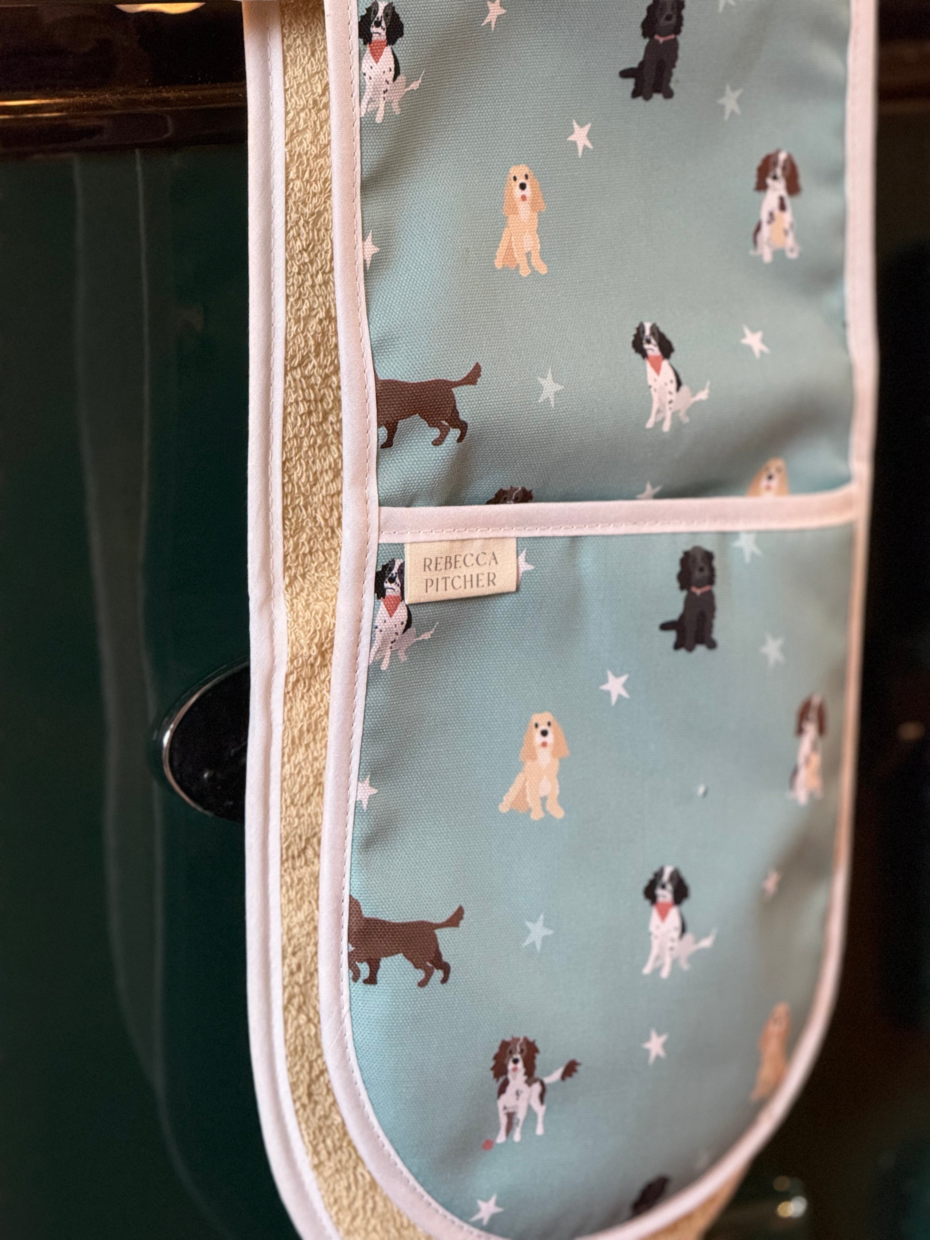Oven mitt with spaniel dog pattern on a duck egg blue background